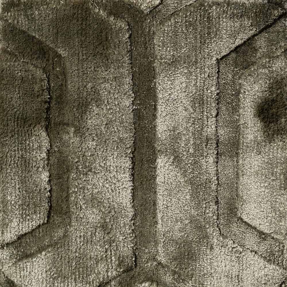 Teppich Liva 200x300 (olive) Nahaufnahme einer strukturierten Oberfläche, möglicherweise Stoff oder Polsterung, mit einem Muster aus erhabenen und vertieften Bereichen, das geometrischen Formen oder Buchstaben ähnelt.